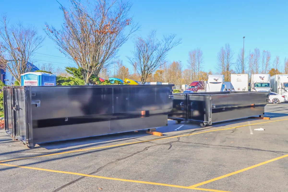 Professional dumpster rental service with roll-off container on residential driveway in Meridianville